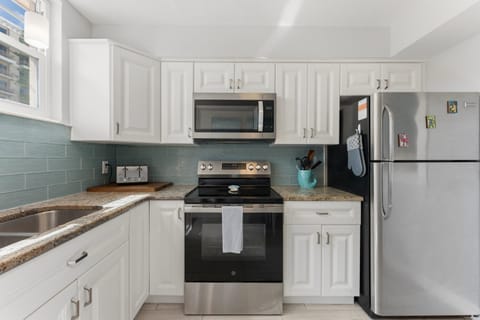 Our full kitchen Features stainless steel appliances including large fridge, stove, oven, blender and  microwave (Note: no dishwasher).