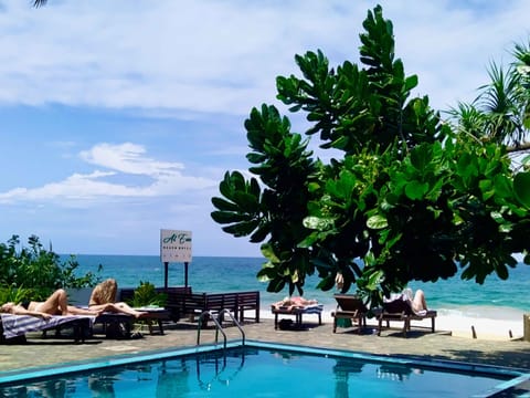 Outdoor pool, open 8:30 AM to 8:30 PM, free cabanas, pool umbrellas