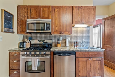 Your fully equipped kitchen features rich wood cabinets, granite counters, and stainless steel appliances for all your culinary adventures.