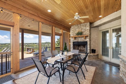 Screened porch with working fireplace, seating, and amazing Ozark views.