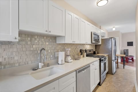 Glass tile surrounds this custom kitchen.