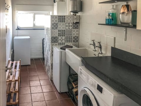 Utility room with laundry facilities | Maes y Mor, Criccieth, near Porthmadog