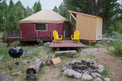 exterior of The Yurt, fire-pit, grilling/sitting area