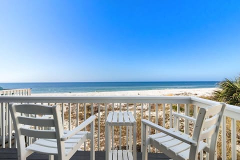Step onto the main-level beachfront deck the moment you arrive — the Gulf is right there, and the day's already better than anything back home.