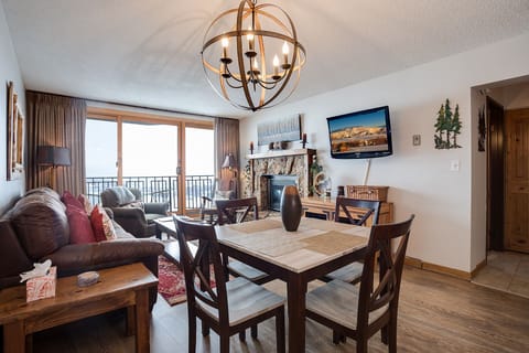 You'll love gathering around this elegant dining table while taking in stunning mountain views through your private balcony doors.
