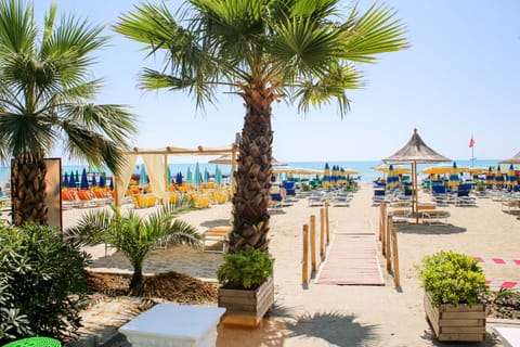 Private beach, white sand, sun loungers, beach umbrellas