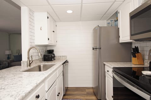 Your fully equipped kitchen features gleaming granite counters, stainless appliances, and everything needed to create memorable meals during your stay.