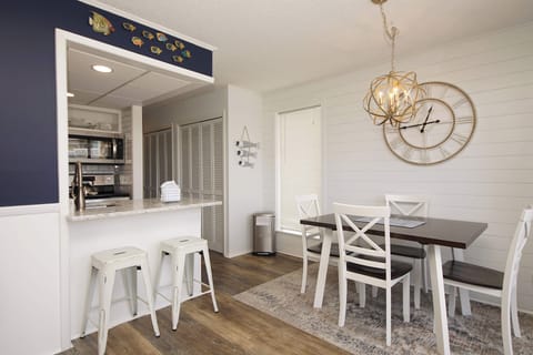 Gather around the stylish dining table or casual breakfast bar where morning coffee and evening conversations flow naturally together.