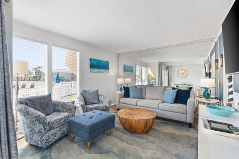 Sink into plush coastal-inspired seating and soak in the natural light streaming through oversized windows. Your peaceful beachside retreat awaits with ocean-themed accents and a relaxing, airy ambiance.