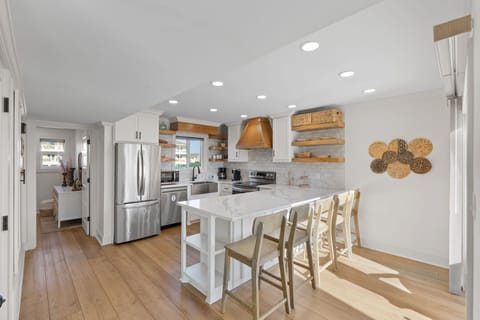 Your bright, open kitchen welcomes you with warm wood accents, marble countertops, and everything needed for memorable meals together.