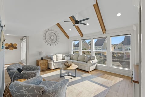 Unwind in your spacious living room with vaulted ceilings and panoramic windows showcasing neighborhood views.