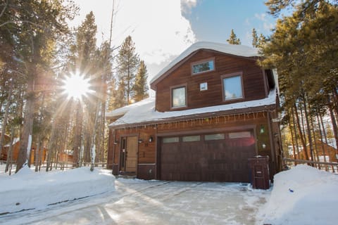 The house is set back on a quiet cul-de-sac surrounded by pine trees
