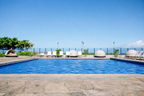 Dive into paradise at this oceanfront pool, complete with comfortable loungers and unique dome cabanas—perfect for lounging under endless blue skies.
