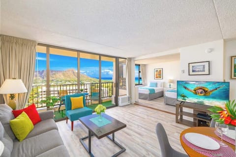 Spacious living space with a pull-out sleeper sofa, a chair, coffee table, and a flat-screen TV.