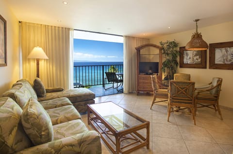 Your oceanfront living room opens to breathtaking blue horizons, where tropical breezes drift through and soft seating invites you to unwind in island-inspired comfort.