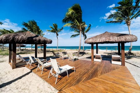 On the beach, white sand, sun loungers, beach umbrellas