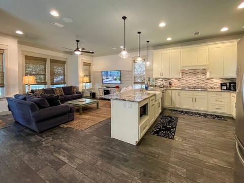 Living area features a large flat screen Smart TV and sound bar