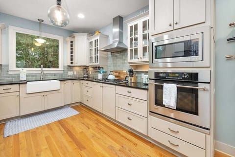 Kitchen with steel appliances and white cabinets