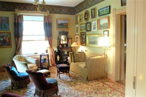 The parlor has comfortable seating and an intriguing collection of art.