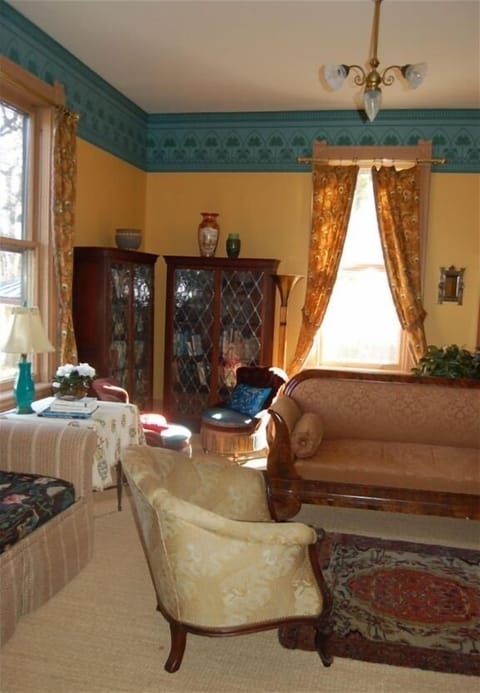 The sunny library offers comfortable seating, flat-screen TV, and lots of books.