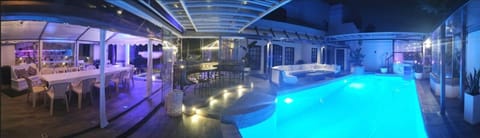 Pool area with adjacent seating, al fresco dining under marque, and amphitheatre