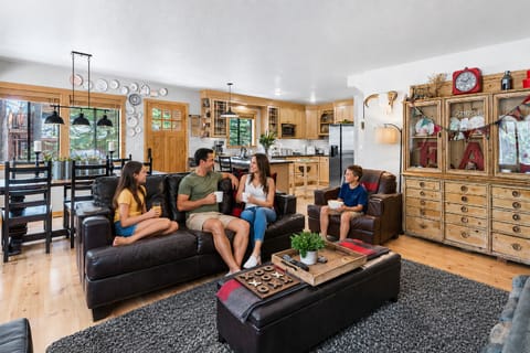 Gather with loved ones in this inviting open-concept space where rustic charm meets modern comfort, perfect for sharing stories and creating memories together.