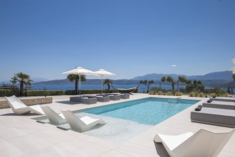 A 50 m² private pool surrounded by sunbeds, umbrellas, hammocks, and cozy seating nooks. Pool heating is available upon request.