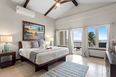 Master bedroom (2nd floor) features king bed, en suite bath, A/C, TV, balcony