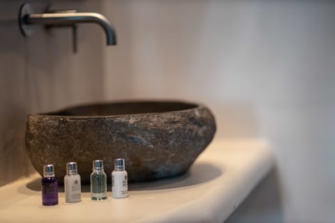 Designer toiletries, hair dryer, slippers, towels