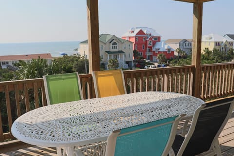 Sip your morning coffee at this charming outdoor dining table while soaking in stunning sea views and colorful coastal homes.