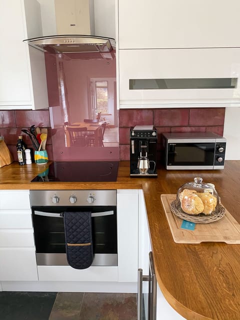 View into kitchen with bean to cup coffee machine 