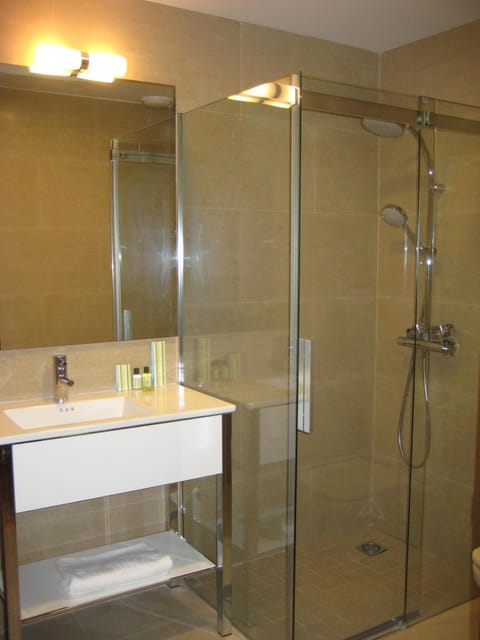 Shower, rainfall showerhead, hair dryer, towels