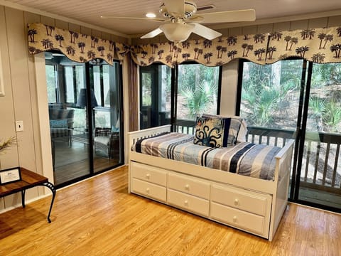 Sunroom with a daybed offers additional sleep area, but is not a private space.