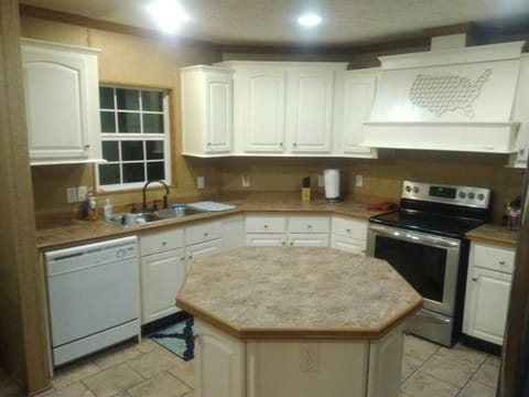 Fully equipped kitchen with pots, pans, and dinnerware