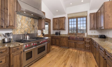 Your gourmet kitchen awaits with rich wood cabinets, granite countertops, and professional-grade appliances for memorable mountain meal preparations.