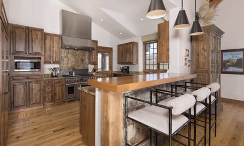 Your gourmet kitchen features rich wood cabinetry, granite countertops, and a spacious island perfect for cooking memorable meals together.