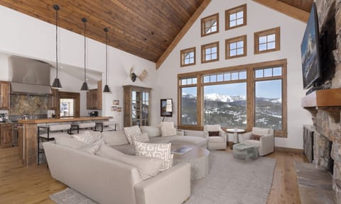 Relax in your soaring great room with vaulted wood ceilings and breathtaking mountain views through floor-to-ceiling windows.