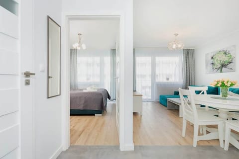 A view from the hallway to the entrance to the cosy bedroom and bright living room. 