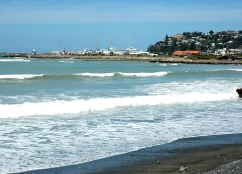 On the beach, black sand, beach towels