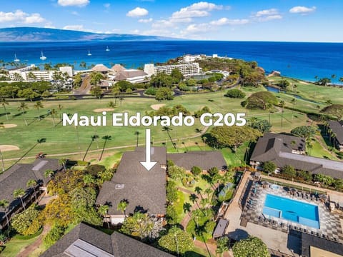 Aerial view of Maui Eldorado framed by lush golf course greens and shimmering ocean views