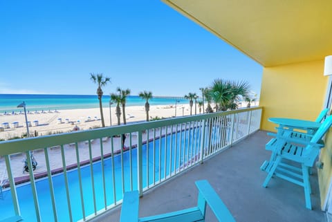 Sip your morning coffee on your private balcony while watching waves roll onto pristine sand. Turquoise chairs invite you to unwind.
