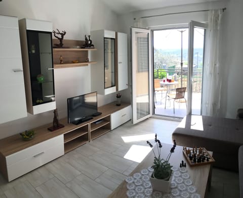 Family Apartment, Multiple Beds, Courtyard View | Living area | Flat-screen TV