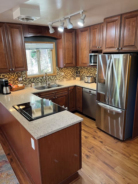 Kitchen with new stainless steel appliances.