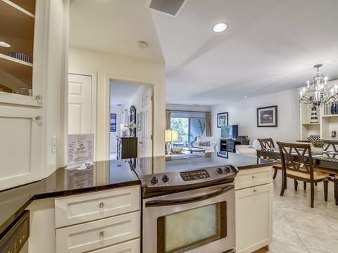 Kitchen Opens to Dining Area and Living Room at 1715 Bluff Villa