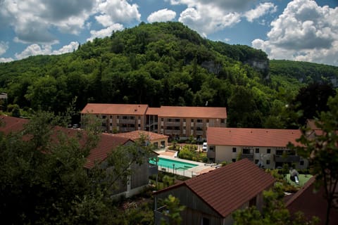 Savor a refreshing dip in the pool surrounded by a picturesque backdrop of trees and hills.