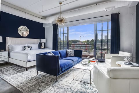 Living and sleeping area at this Ponce Rental with couches and bed