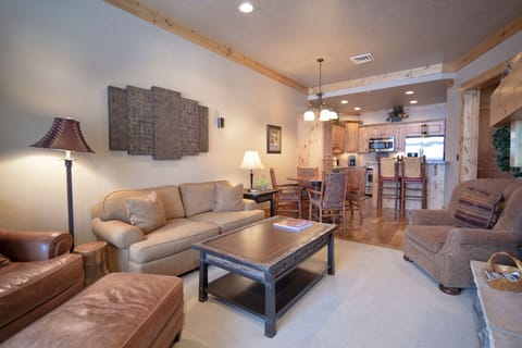 Sink into the plush sofas of your spacious living area, where rustic wood beams and warm lighting create the perfect atmosphere for your mountain getaway conversations.