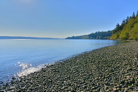 Beach looking south at medium tide. At low tide walk out to a sand beach.