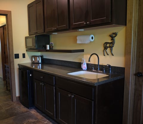 Kitchenette with mini fridge, microwave, and toaster on Upper Level in Suite