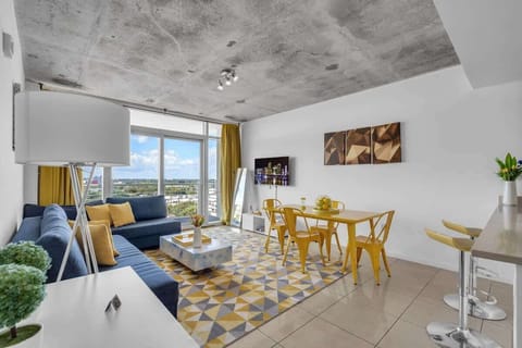 "Relax in this vibrant Airbnb apartment with city views, cozy seating, and stylish dining space."

